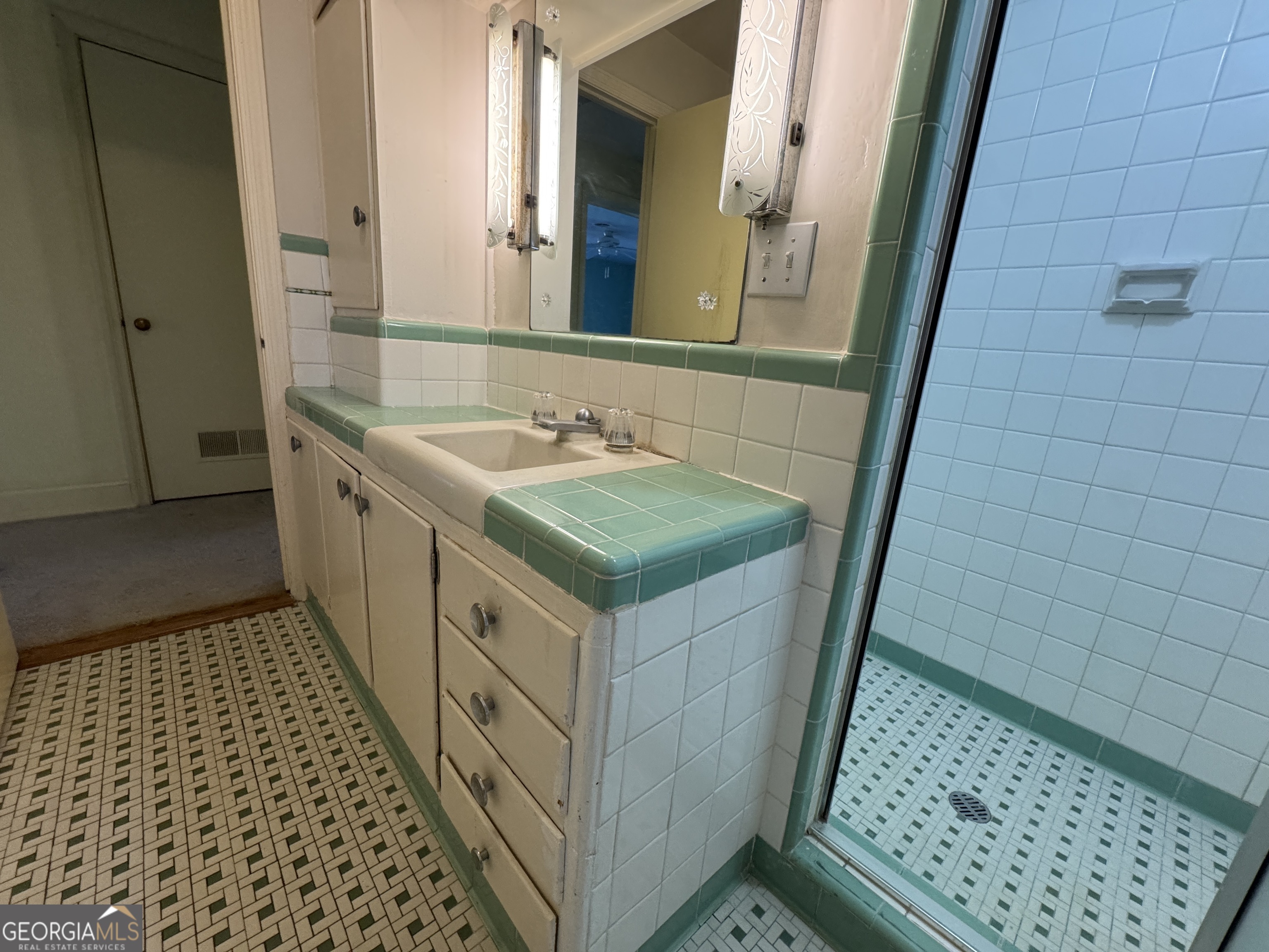 465 Cedar Street Metter, GA 30439 - Photo 20 of 47 a bathroom with a sink and a mirror