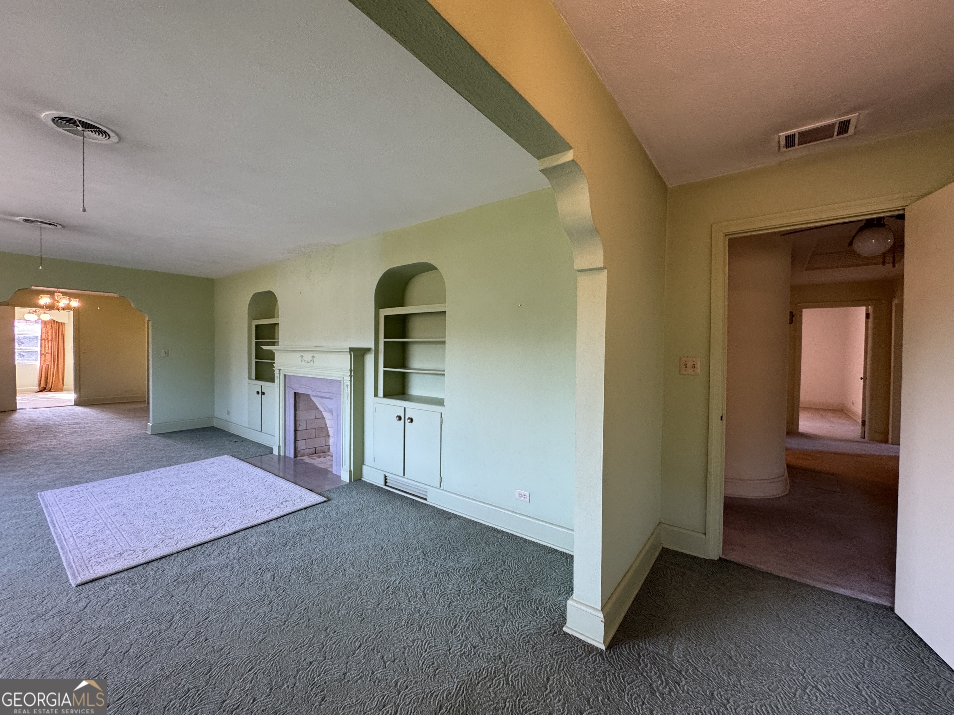 465 Cedar Street Metter, GA 30439 - Photo 34 of 47 a spacious bedroom with a bed and a view of kitchen