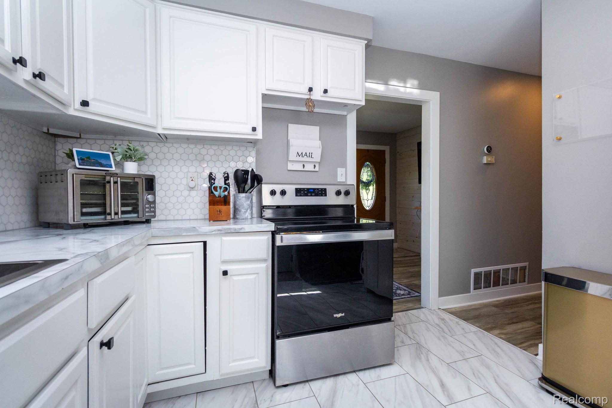 2559 Harrison Avenue Rochester, MI 48307 - Photo 13 of 32 Stainless steel range, and light-toned tile flooring