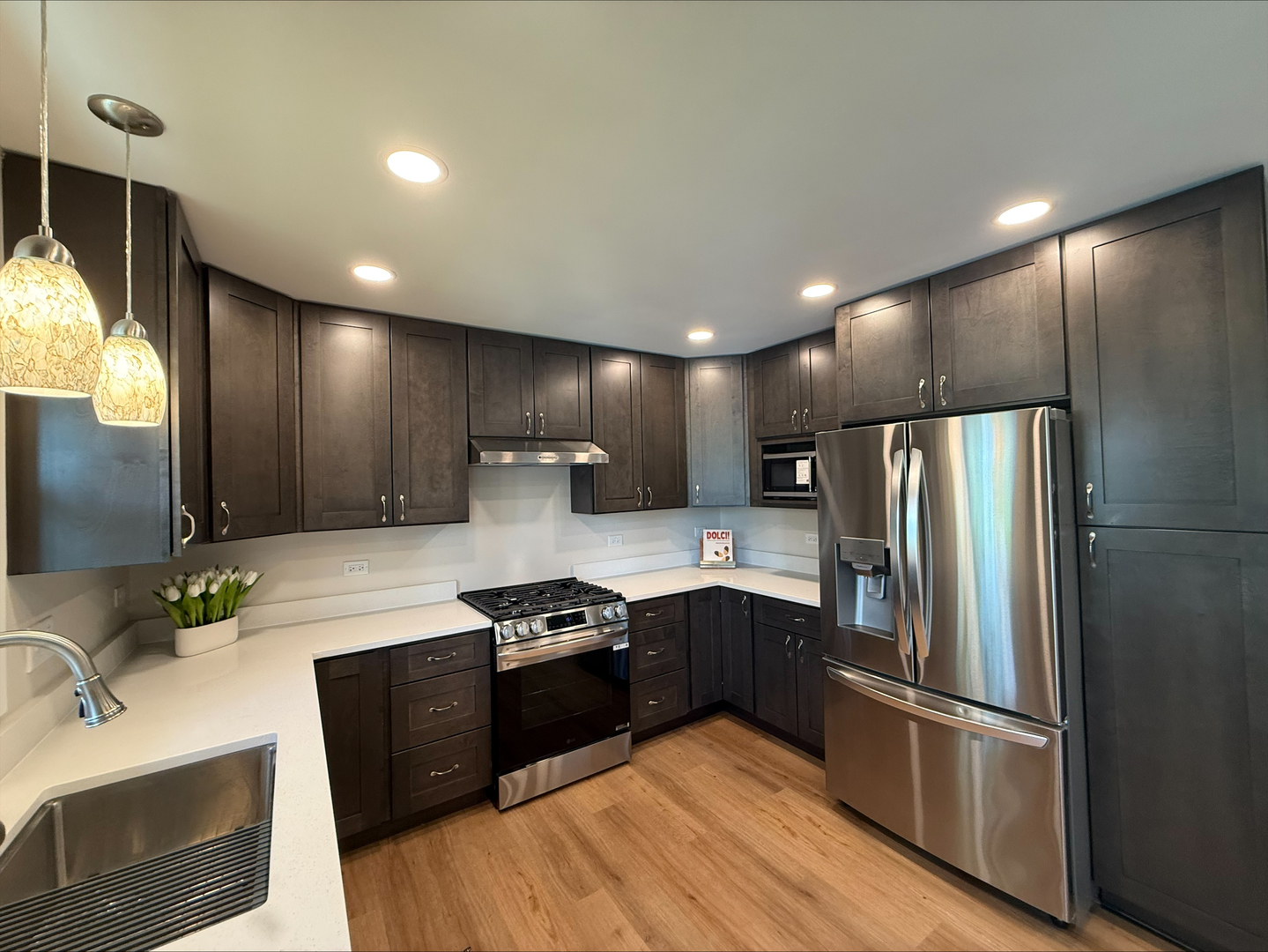 289 Chestnut Street Antioch, IL 60002 - Photo 15 of 24 a kitchen with stainless steel appliances granite countertop a refrigerator a sink dishwasher a stove and white countertops with wooden floor