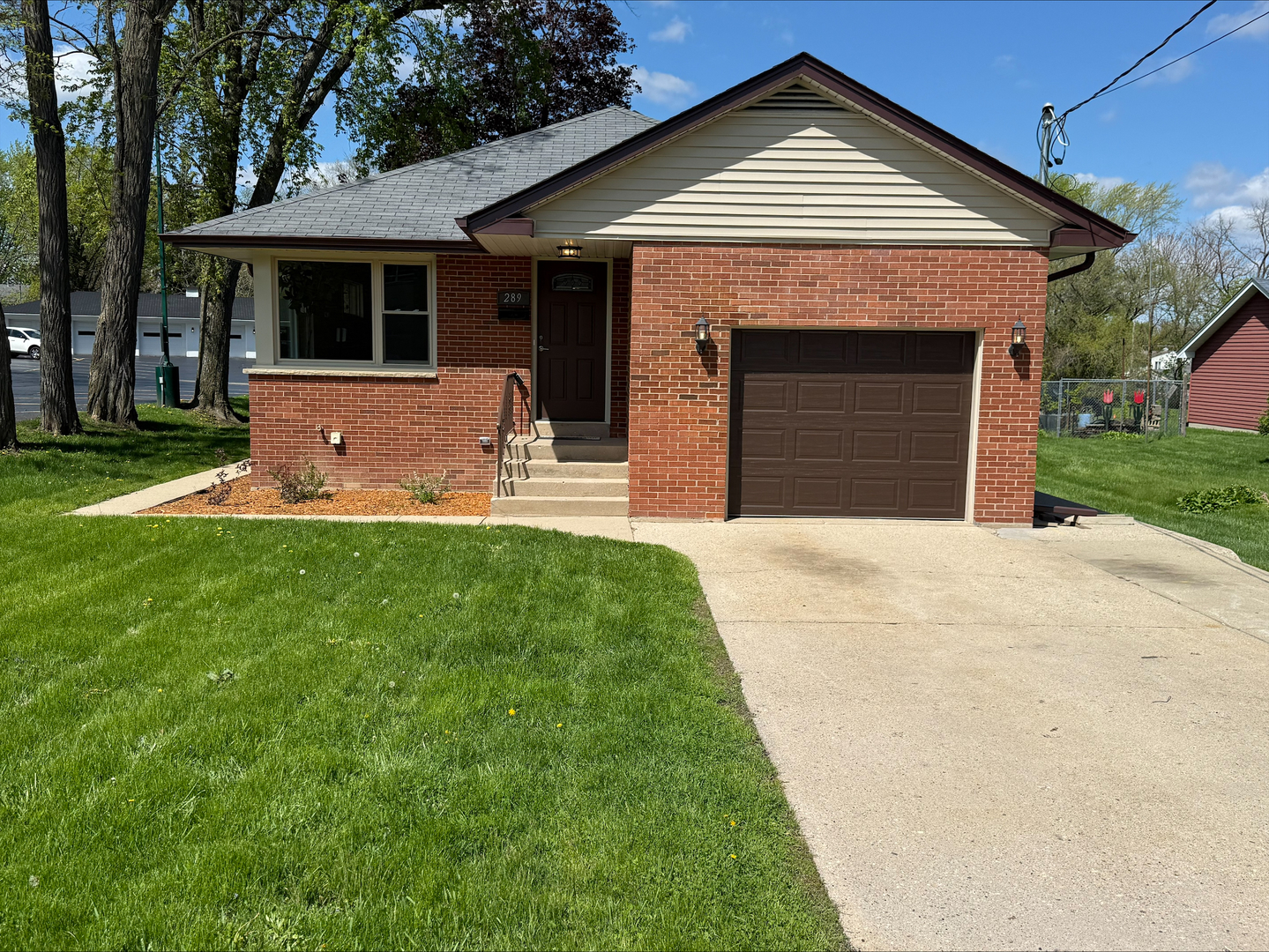 289 Chestnut Street Antioch, IL 60002 - Photo 2 of 24 a front view of a house with a yard and garage