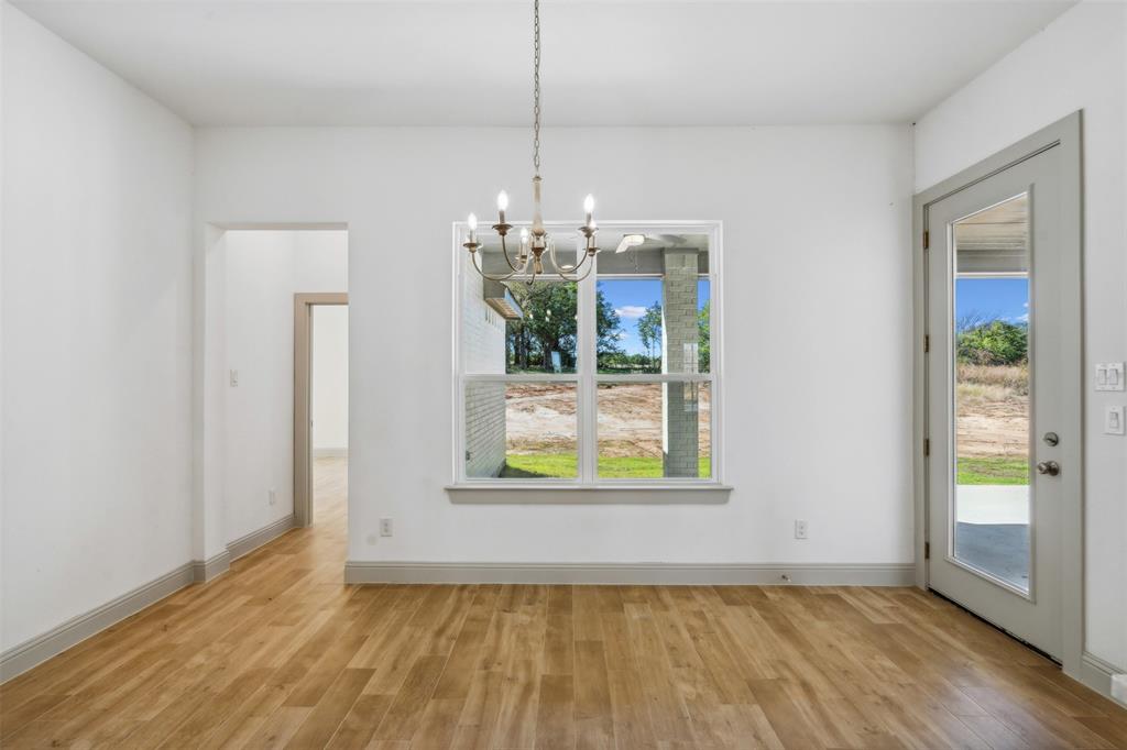 191 Lucky Ridge Lane Boyd, TX 76023 - Photo 14 of 38 a view of an empty room with window and wooden floor