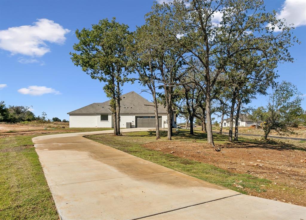 191 Lucky Ridge Lane Boyd, TX 76023 - Photo 2 of 38 a front view of a house with a yard and trees