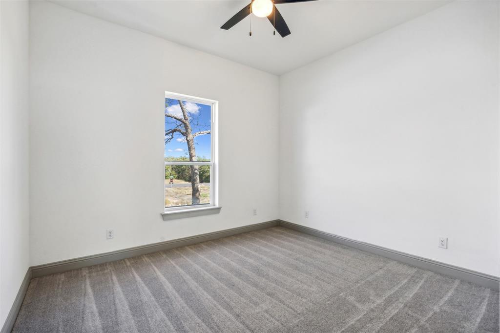 191 Lucky Ridge Lane Boyd, TX 76023 - Photo 23 of 38 an empty room with ceiling fan and window