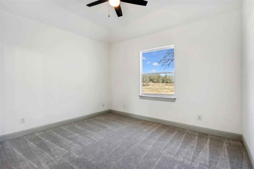 191 Lucky Ridge Lane Boyd, TX 76023 - Photo 24 of 38 an empty room with a window and ceiling fan