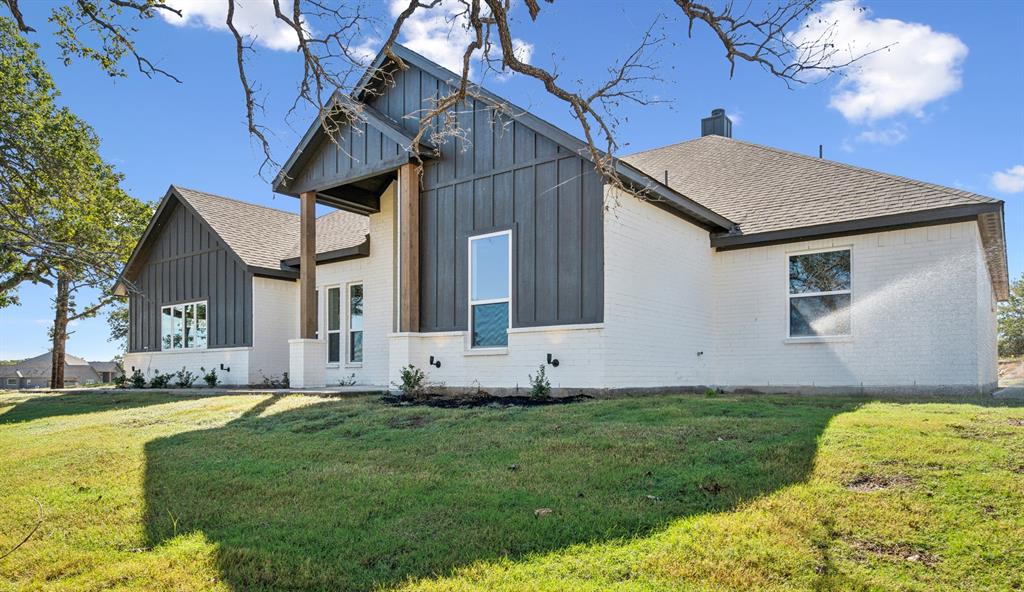 191 Lucky Ridge Lane Boyd, TX 76023 - Photo 4 of 38 a front view of a house with a yard