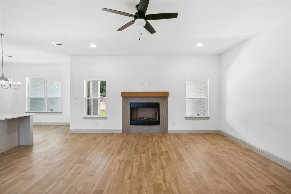 191 Lucky Ridge Lane Boyd, TX 76023 - Photo 9 of 38 a view of an empty room with a window and fireplace