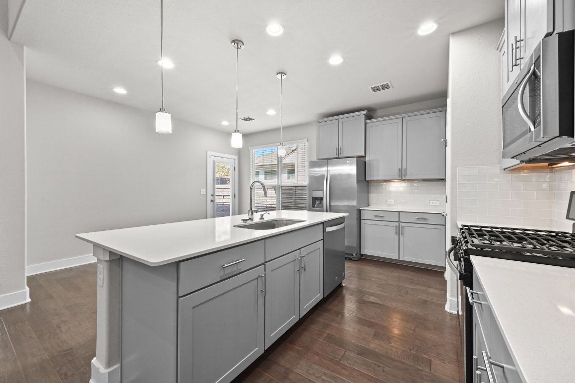2108 Hermia Street Austin, TX 78741 - Photo 13 of 28 a kitchen with a sink stainless steel appliances and cabinets