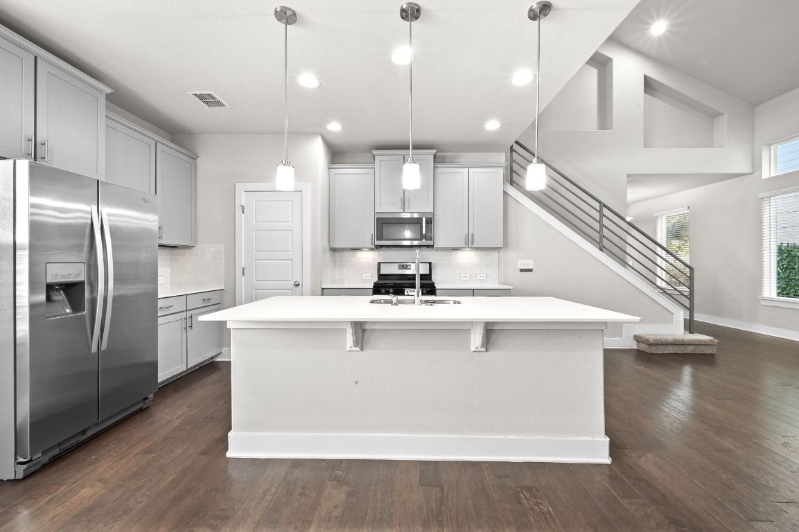 2108 Hermia Street Austin, TX 78741 - Photo 14 of 28 a view of kitchen with stainless steel appliances granite countertop a sink a refrigerator and a stove