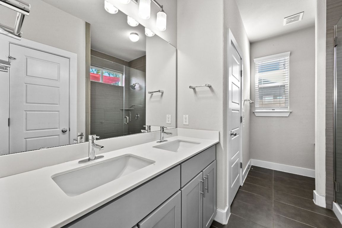 2108 Hermia Street Austin, TX 78741 - Photo 15 of 28 a bathroom with a sink and a mirror