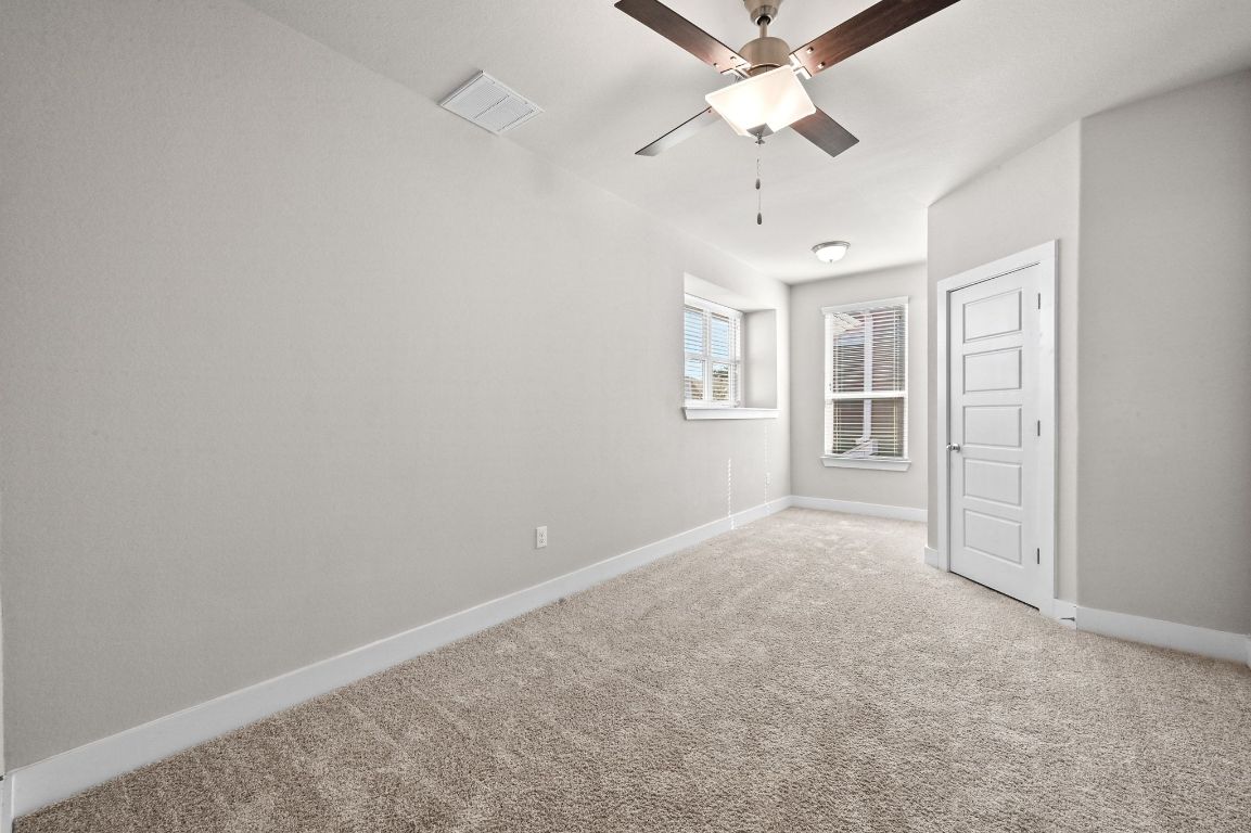 2108 Hermia Street Austin, TX 78741 - Photo 19 of 28 an empty room with windows and fan