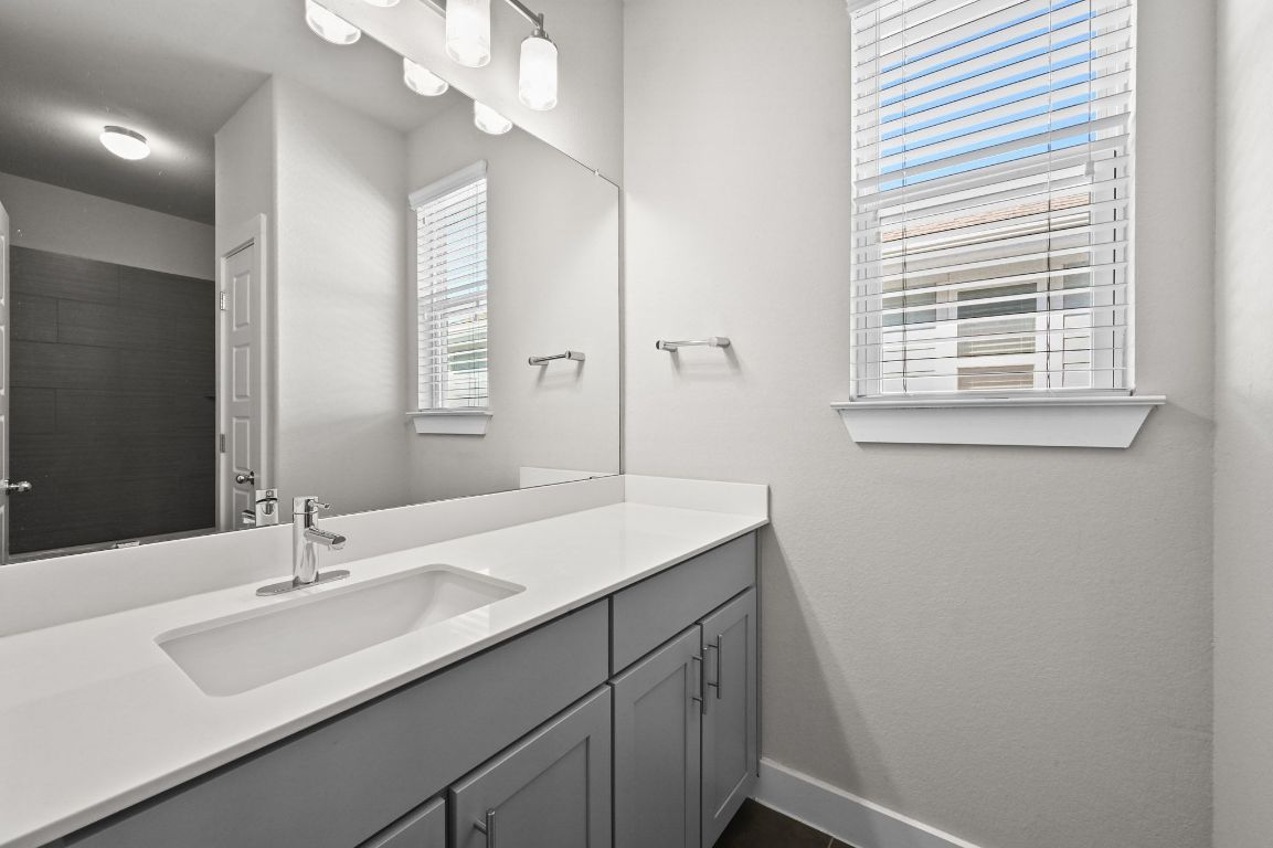 2108 Hermia Street Austin, TX 78741 - Photo 21 of 28 a bathroom with a sink a vanity and a mirror