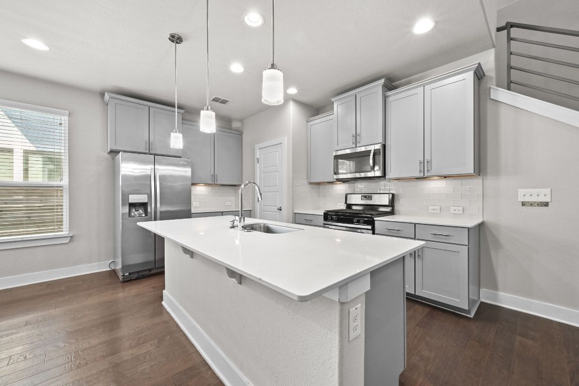 2108 Hermia Street Austin, TX 78741 - Photo 5 of 28 a kitchen with a sink a counter top space stainless steel appliances and cabinets