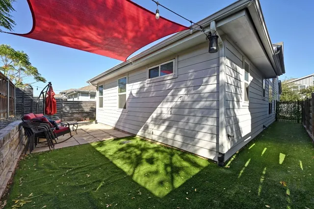 a view of a chair and table in backyard