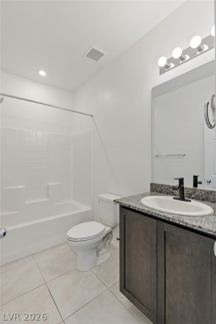 6227 Runestone Street Las Vegas, NV 89113 - Photo 24 of 33 Bright and clean bathroom featuring a practical shower-tub combination.