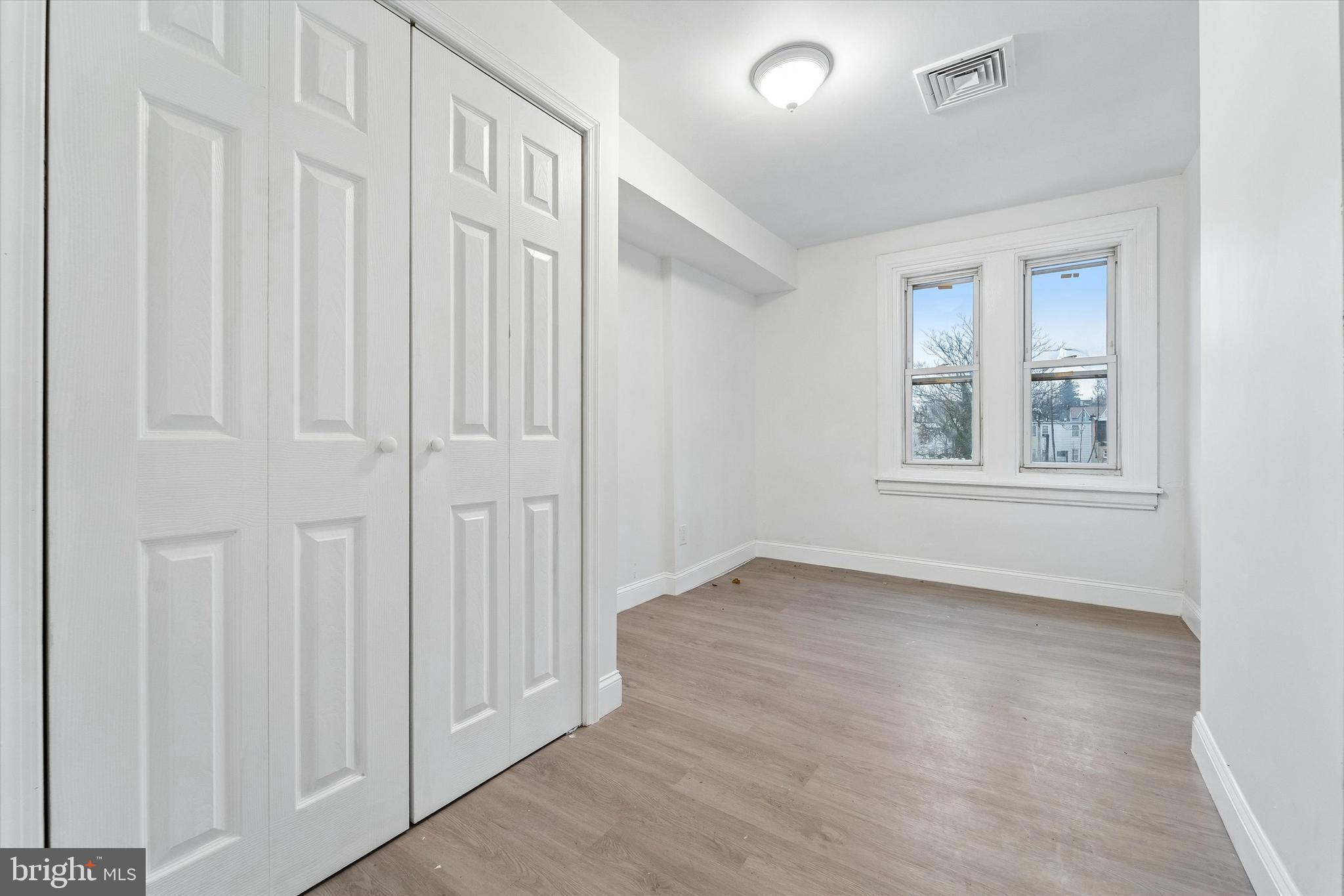 79 High Street, Unit 2 Philadelphia, PA 19144 - Photo 14 of 17 an empty room with wooden floor and windows