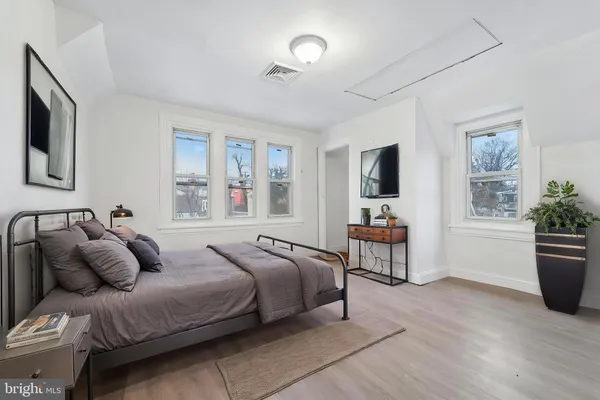 a bedroom with a large bed and a window