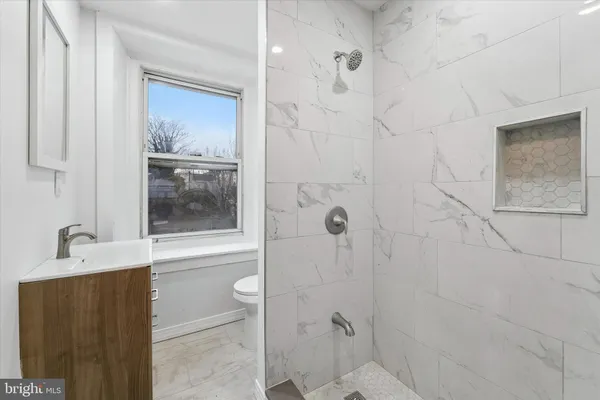 a bathroom with a granite countertop bathtub shower sink and mirror