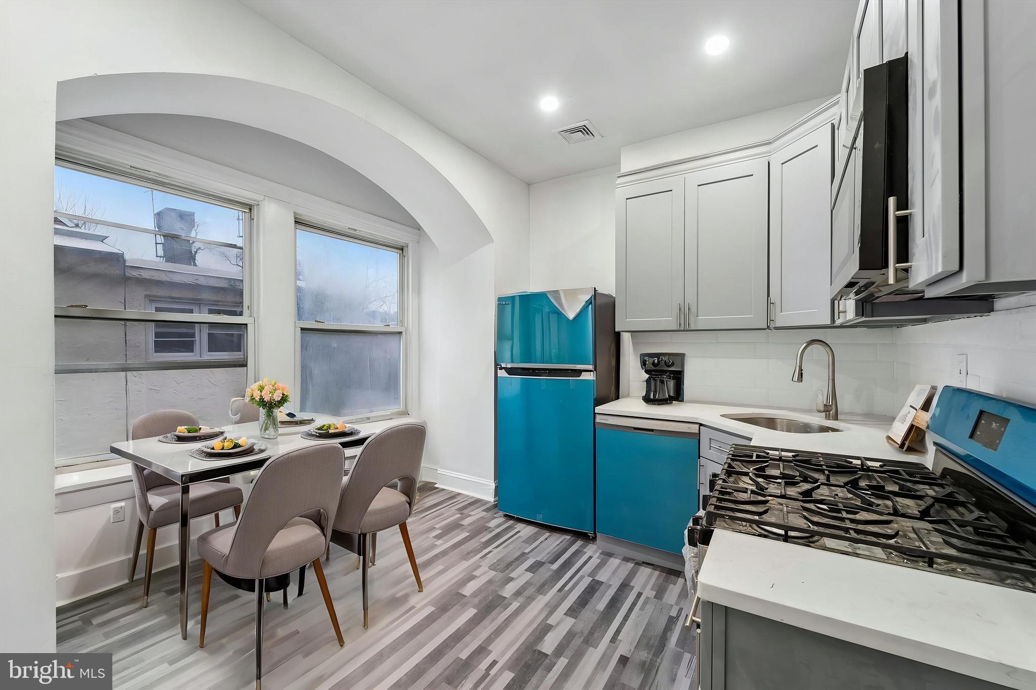 79 High Street, Unit 2 Philadelphia, PA 19144 - Photo 3 of 17 a kitchen with granite countertop a stove a sink and a refrigerator