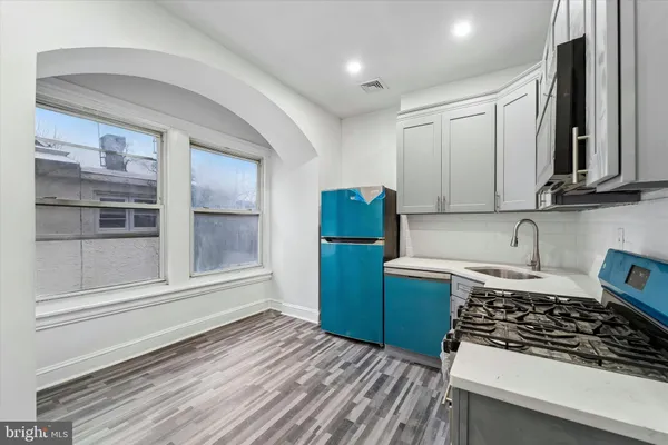 a kitchen with sink cabinets and stove