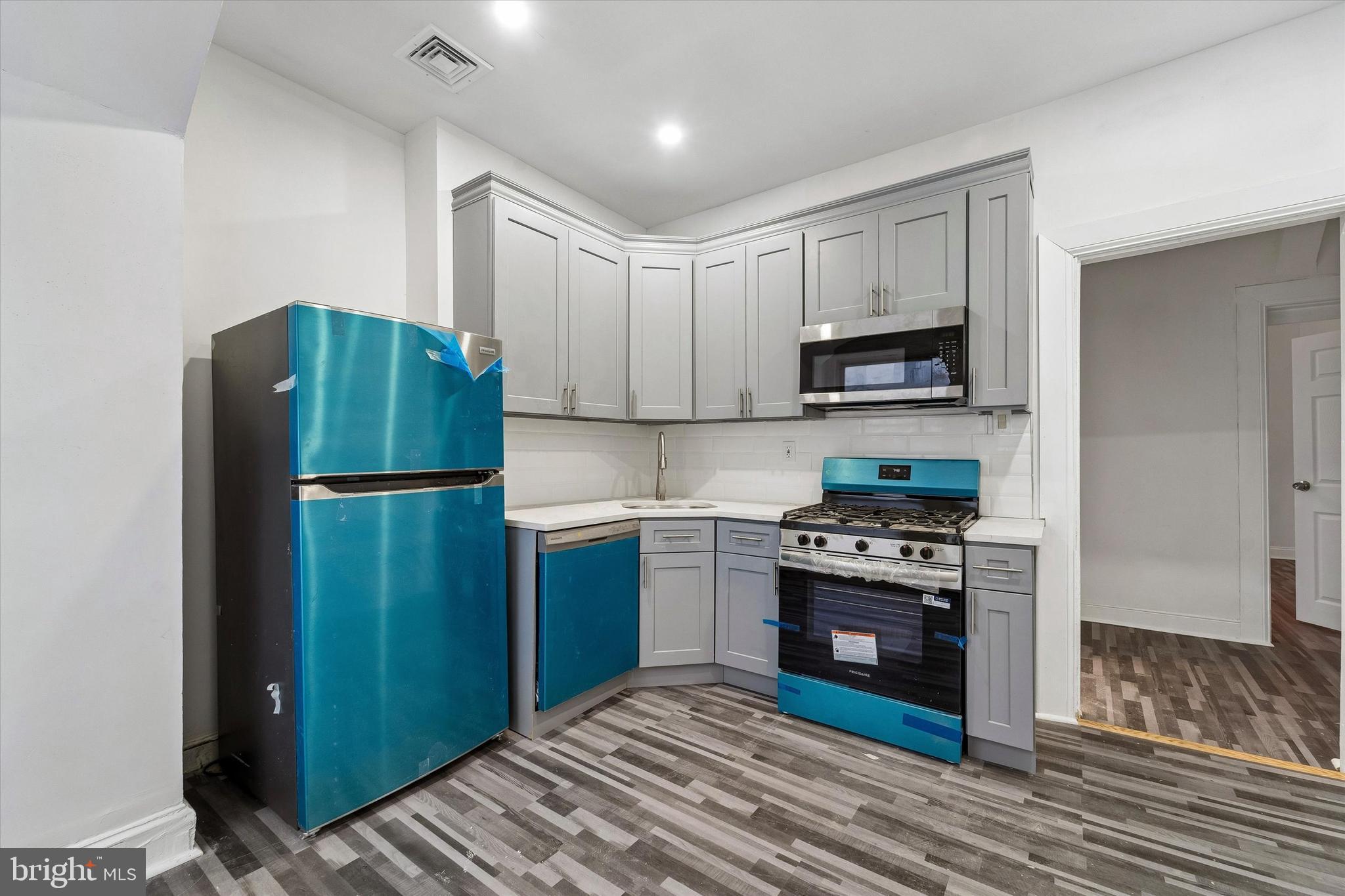 79 High Street, Unit 2 Philadelphia, PA 19144 - Photo 5 of 17 a kitchen with a refrigerator and a stove top oven