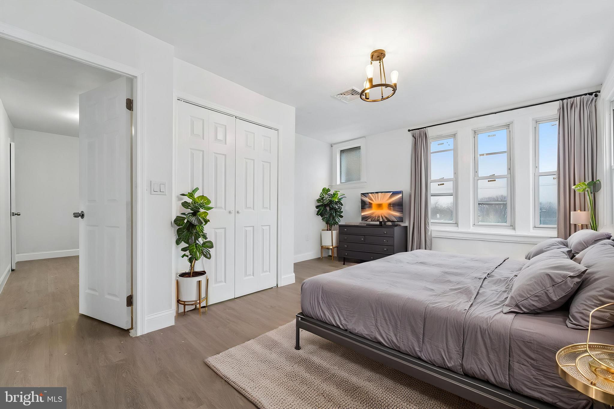 79 High Street, Unit 2 Philadelphia, PA 19144 - Photo 8 of 17 a bedroom with a bed and a chandelier