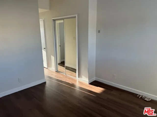 an empty room with wooden floor