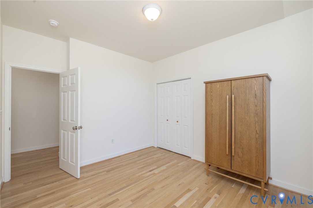 15618 Rowlett Road Chesterfield, VA 23838 - Photo 14 of 29 an empty room with wooden floor and closet