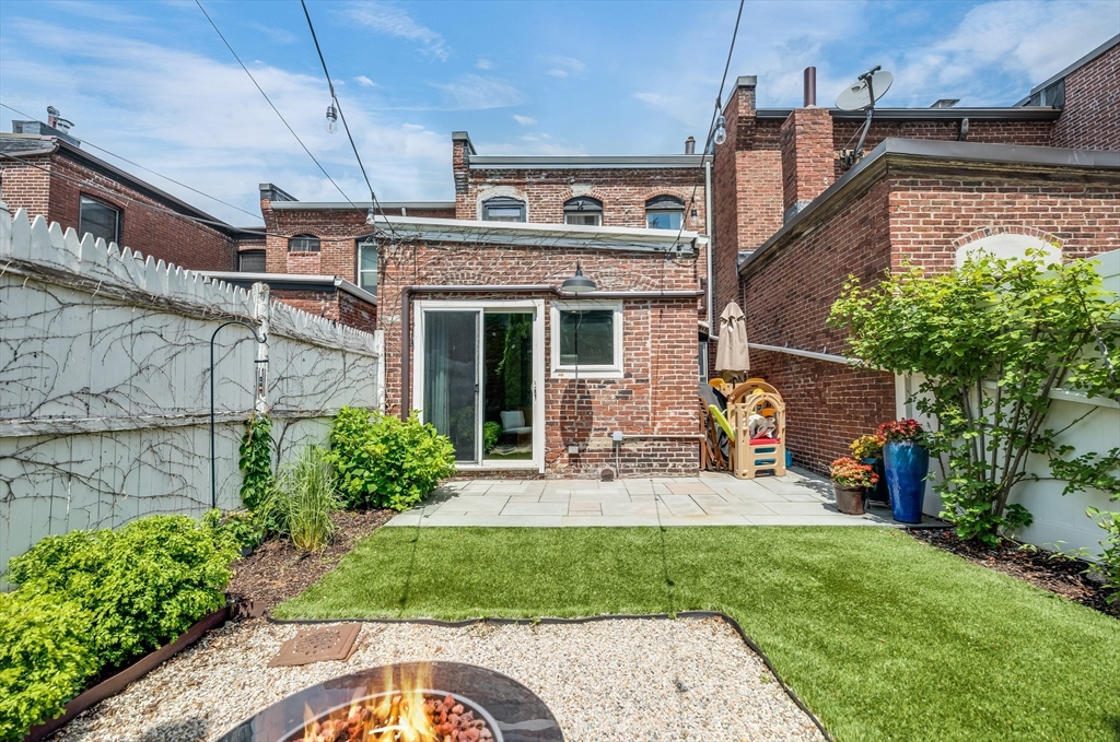 39 Emerson Street Boston, MA 02127 - Photo 11 of 20 a front view of a house with a garden and plants