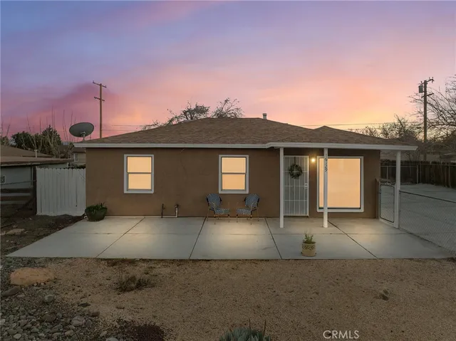 a front view of a house with a garden and garage