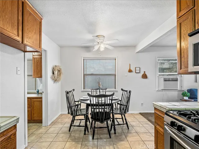 a kitchen with kitchen island granite countertop stainless steel appliances a sink dishwasher stove and cabinets with wooden floor