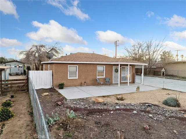 a front view of a house with a yard and seating space
