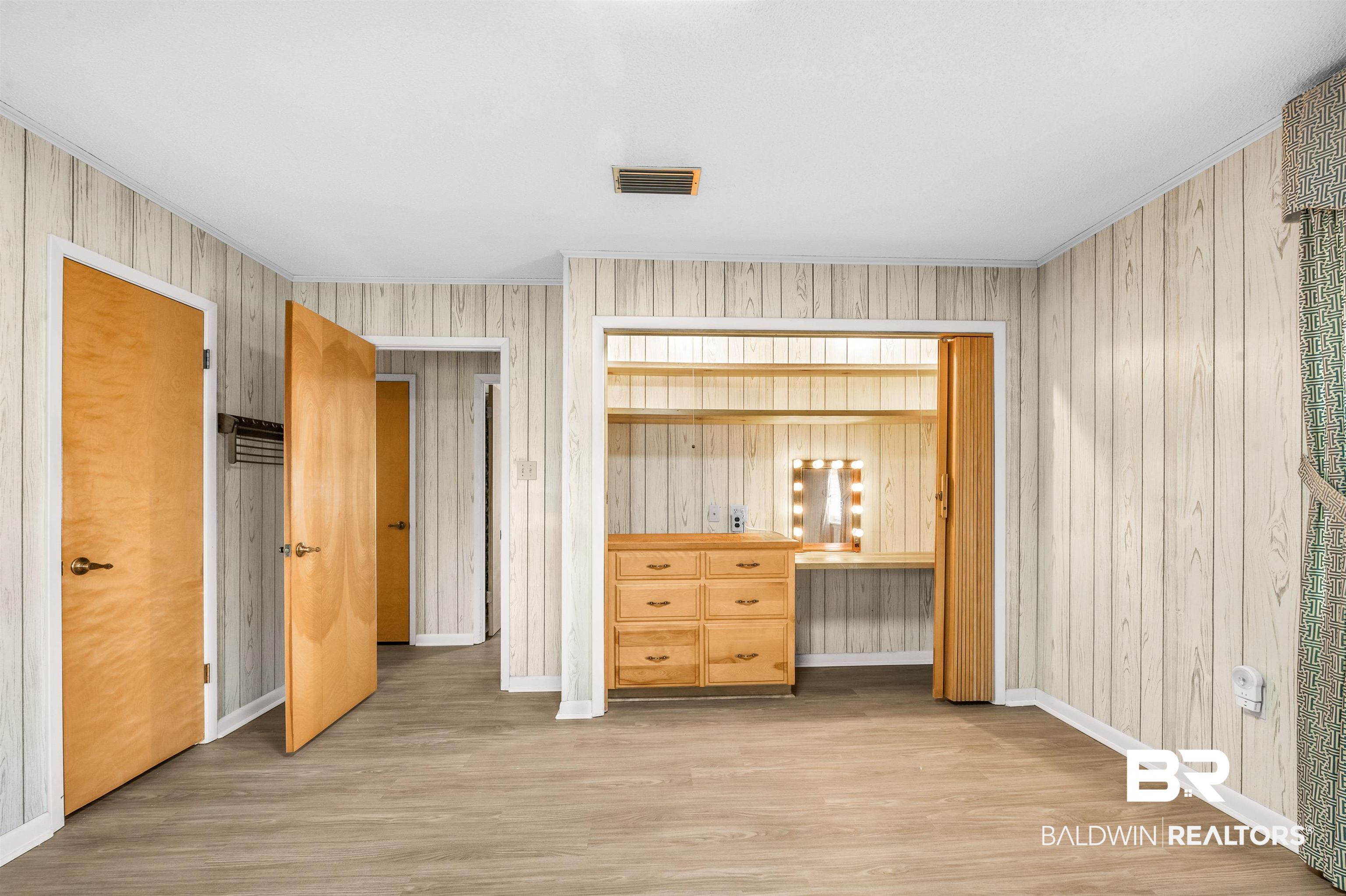 610 East Walker Avenue Foley, AL 36535 - Photo 32 of 38 Bedroom featuring crown molding and wood finished floors