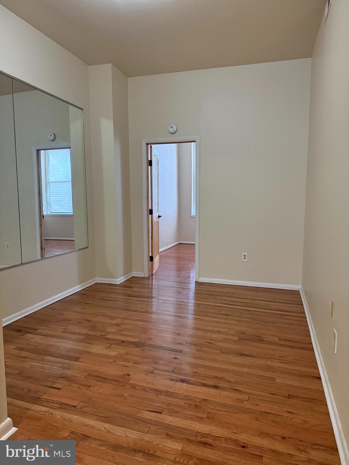 2005 Madison Avenue, Unit 2 Baltimore, MD 21217 - Photo 11 of 16 a view of an empty room with wooden floor and closet