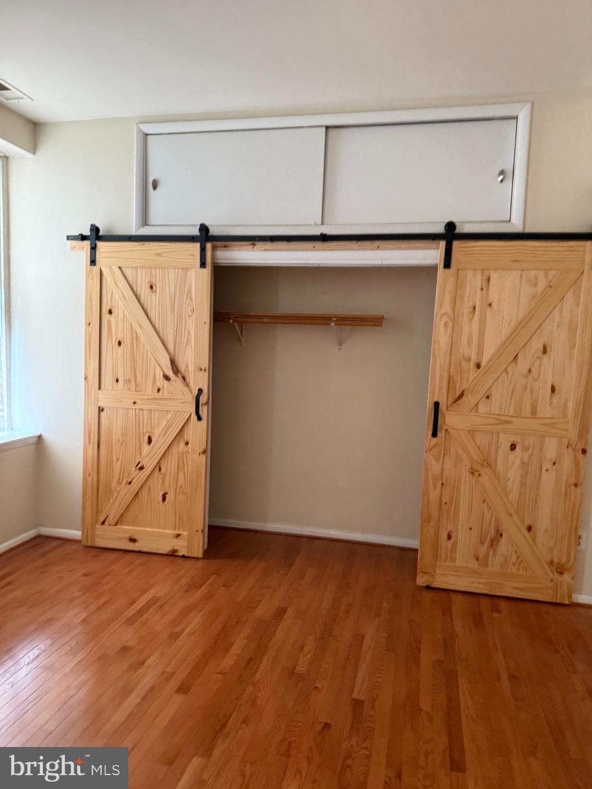 2005 Madison Avenue, Unit 2 Baltimore, MD 21217 - Photo 12 of 16 a view of an empty room with wooden floor