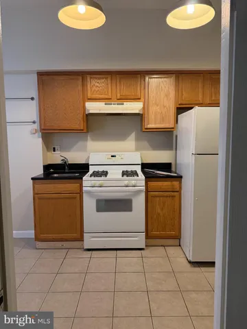 a kitchen with a stove and a refrigerator
