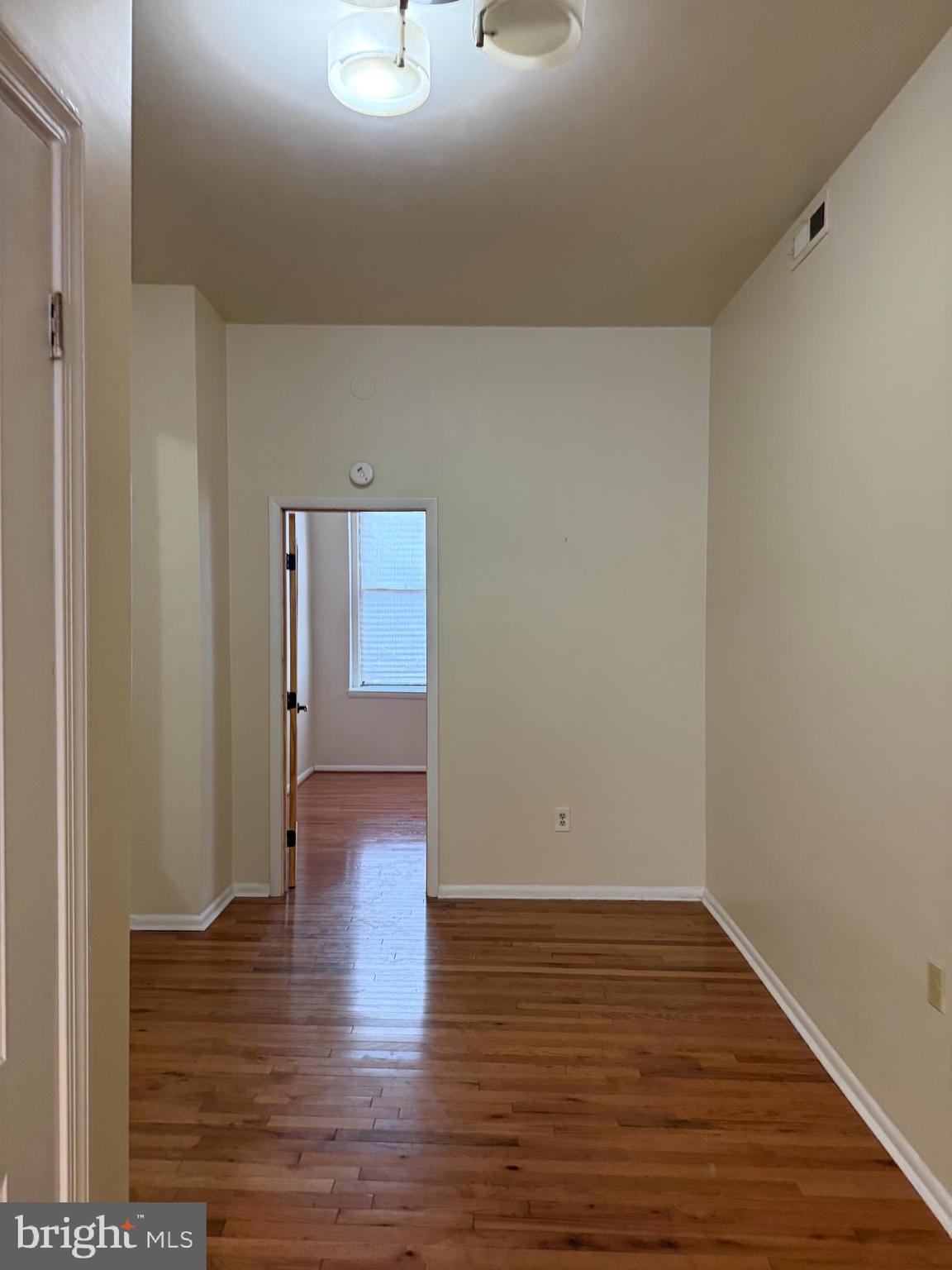 2005 Madison Avenue, Unit 2 Baltimore, MD 21217 - Photo 10 of 16 a view of an empty room with wooden floor
