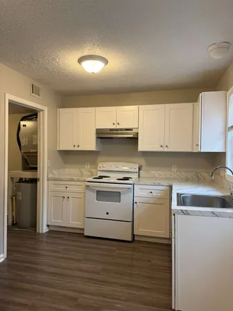 a kitchen with a stove oven and sink