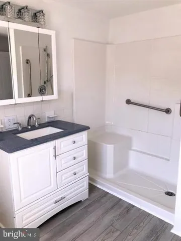 a bathroom with a sink a vanity and a mirror