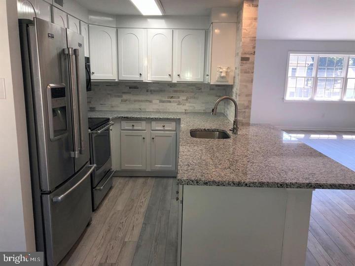75 South Main Street Yardley, PA 19067 - Photo 6 of 29 a kitchen with stainless steel appliances granite countertop a sink stove and refrigerator