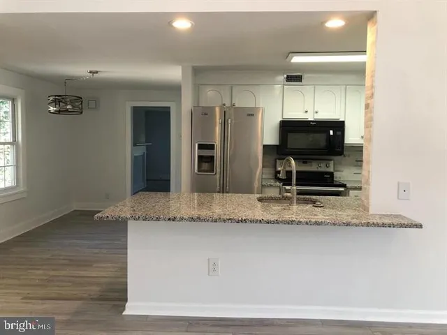 a view of living room with furniture and a flat screen tv