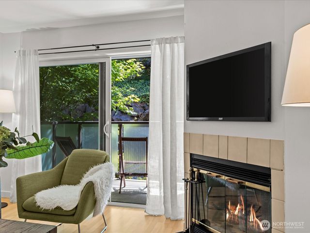 a living room with furniture a flat screen tv and a fireplace