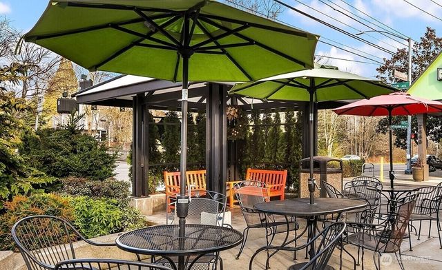 a view of a patio with a table and chairs under an umbrella