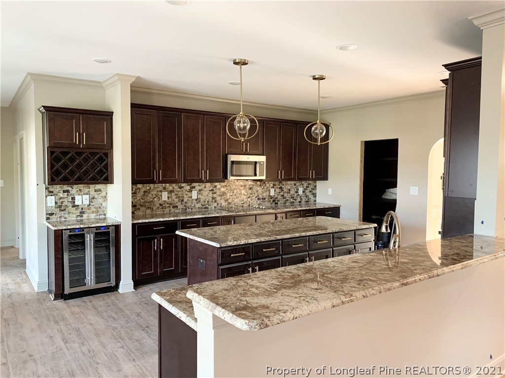 654 Townsend Road Raeford, NC 28376 - Photo 6 of 6 a kitchen with stainless steel appliances granite countertop a stove a sink and a microwave
