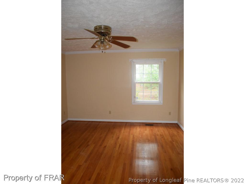 26861 Harold Morris Road Wagram, NC 28396 - Photo 13 of 24 a picture of a room with a window and wooden floor
