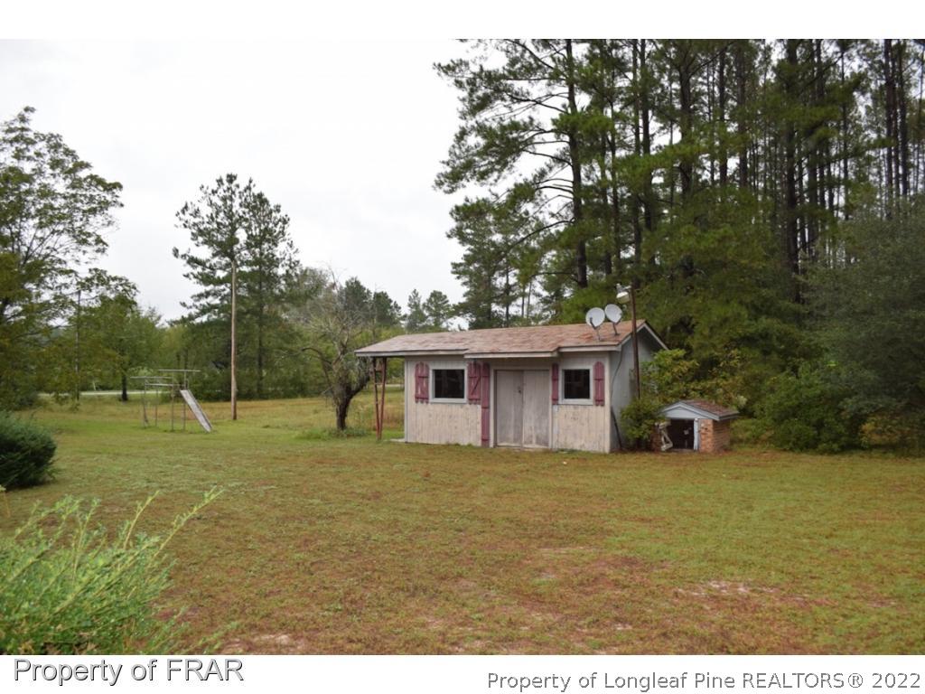 26861 Harold Morris Road Wagram, NC 28396 - Photo 23 of 24 a view of a backyard with large trees