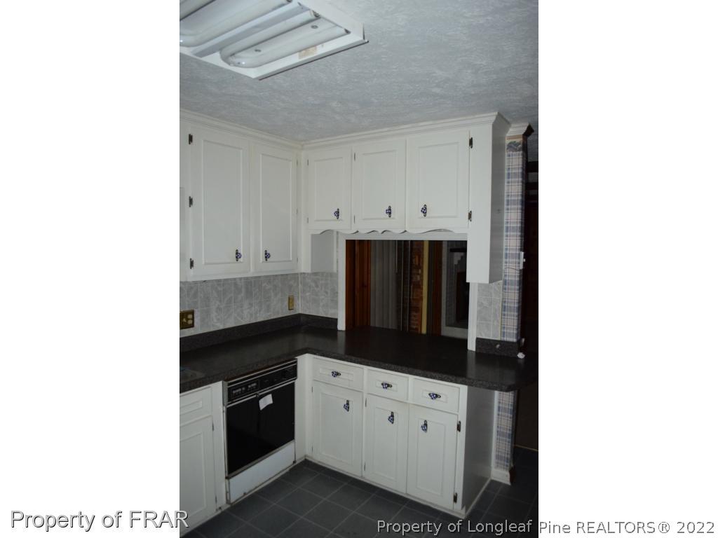 26861 Harold Morris Road Wagram, NC 28396 - Photo 7 of 24 a kitchen with cabinets and window