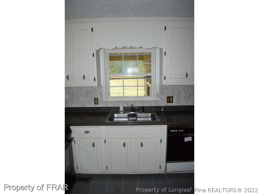 26861 Harold Morris Road Wagram, NC 28396 - Photo 8 of 24 a kitchen with a sink and cabinets
