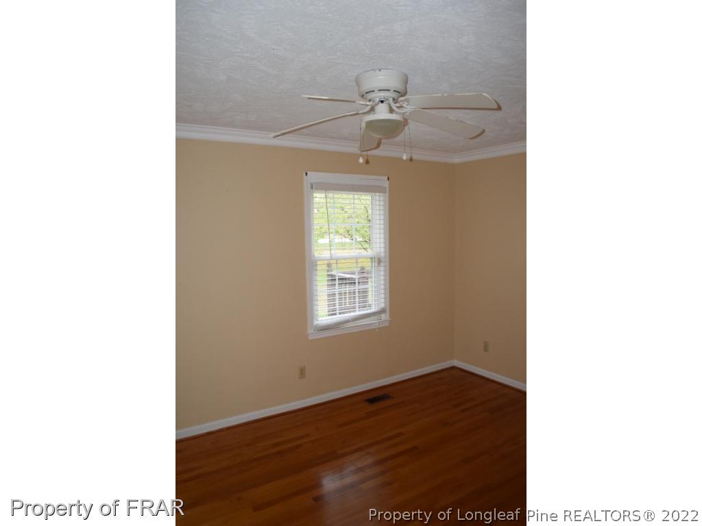 26861 Harold Morris Road Wagram, NC 28396 - Photo 10 of 24 a picture of a room that has a window and wooden floor