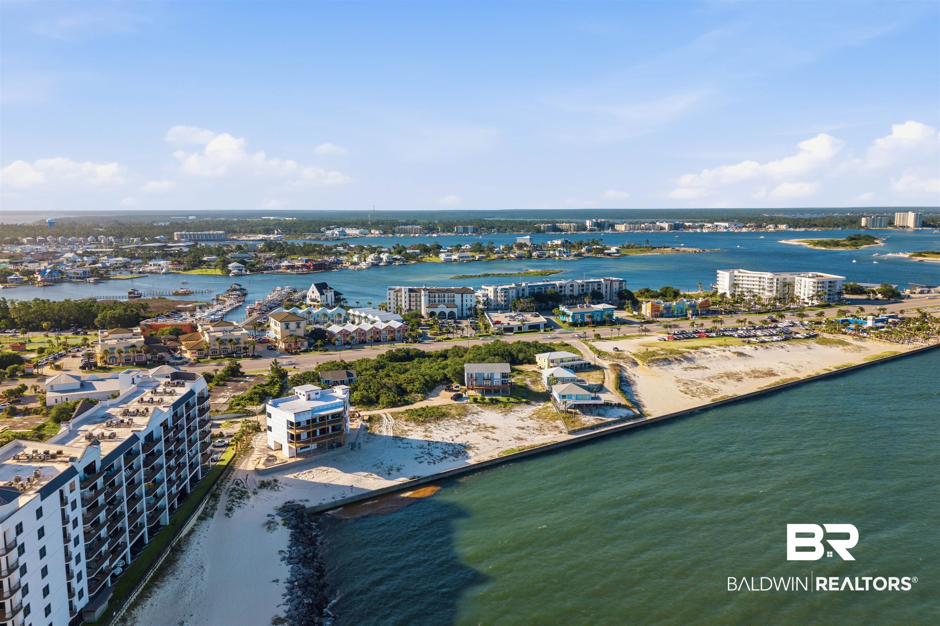 3564 Bayou Road, Unit 203 Orange Beach, AL 36561 - Photo 48 of 53 Coastal landscape featuring multiple waterfront properties, sandy beaches, and a marina with various boats